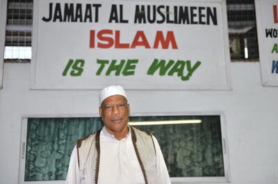 In this photo taken May 3, 2013, Yasin Abu Bakr, the head of the Jamaat al Muslimeen group that attempted a coup in Trinidad & Tobago in 1990, pose for a picture at the group's compound in Port-of-Spain, Trinidad. Nearly 23 years have passed since the homegrown group of radical Muslims stormed Trinidad & Tobago's parliament and began spraying gunfire, setting off six days of chaos that killed two dozen people. A fact-finding commission is trying to find the motive behind the violent upheaval by 114 Muslim rebels and the exact circumstances of how people were killed during the subsequent looting and arson that engulfed parts of the capital. (AP Photo/David McFadden)