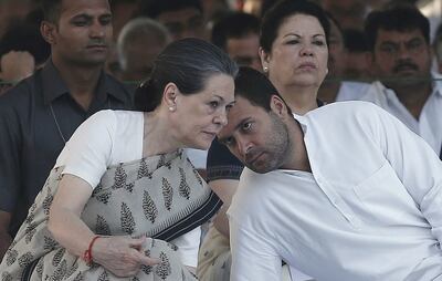 India's Congress party chief Sonia Gandhi listens to her son Rahul Gandhi during her husband and former Indian prime minister Rajiv Gandhi's memorial. Reuters