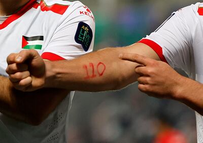 Footballer Mohammed Saleh of Palestine displays the number 110 on his arm, marking the number of days since Israel's war in Gaza began. Reuters