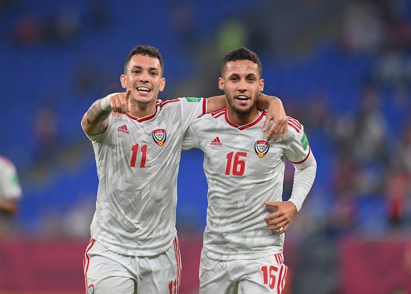 UAE forward Caio Canedo celebrates with teammate Ali Saleh after opening the scoring against Syria.