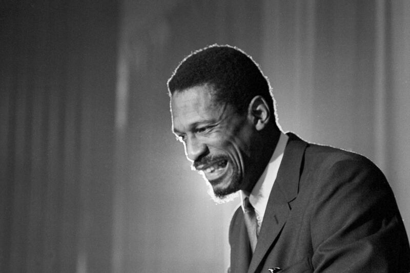 Bill Russell grins at announcement that he had been named coach of the Boston Celtics basketball team in 1966. AP