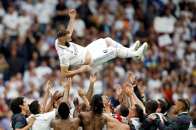 Real Madrid players throw Karim Benzema in the air after the match. Reuters