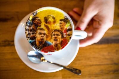 A picture shows a coffee cup, covered by a printed image displaying Croatian and French national football teams in Zagreb on July 14, 2018, ahead of the 2018 Russia World Cup final football match between Croatia and France, the first final World Cup match ever in the history of Croatia. / AFP / ANDREJ ISAKOVIC
