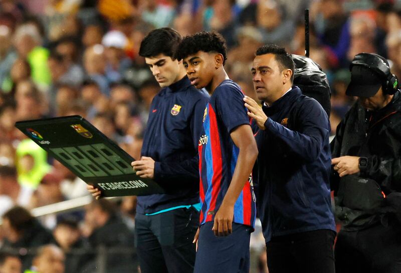 Soccer Football - LaLiga - FC Barcelona v Real Betis - Camp Nou, Barcelona, Spain - April 29, 2023 FC Barcelona's Lamine Yamal with coach Xavi REUTERS / Albert Gea