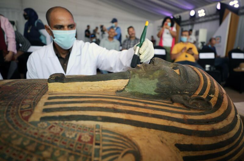 Egyptian archeologists work on one of the sarcophagi discovered at Saqqara Necropolis, Giza, Egypt.  An Egyptian archaeological mission uncovered a total of 59 intact and sealed coffins in three burial shafts dozen of meters deep in the Saqqara necropolis.EPA