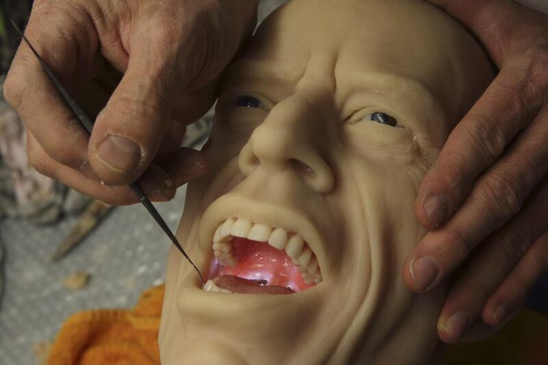 Sculptor Eric Saint Chaffray puts the teeth and tongue inside the head of Rolling Stones lead singer Mick Jagger at their workshop in Paris on March 10, 2014. Philippe Wojazer / Reuters 