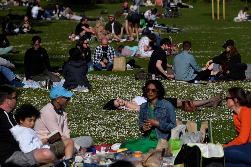 People relax in St. James's Park, London. Reuters