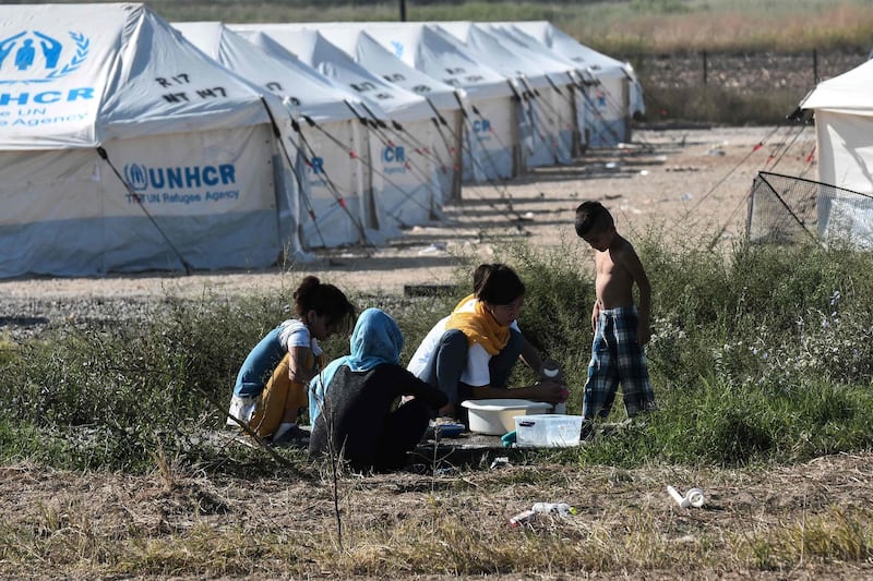 Children play after arriving at Nea Kavala refugee camp, near the city of Kilkis, northern Greece.  Some 1000 refugees and migrants were transferred from the Greek island of Lesbos to the Nea Kavala camp under a decision taken by the Greek government at an emergency meeting on August 31.  AFP