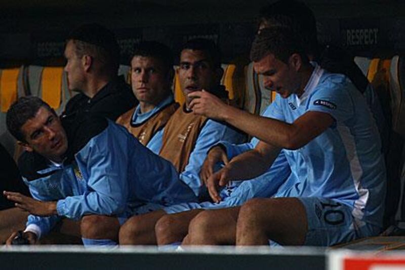Carlos Tevez, centre, looks unmoved on the bench after the Bosnian striker Edin Dzeko was substituted in their Champions League match at Bayern Munich.