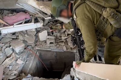 An Israeli soldier checks an entrance to a tunnel allegedly used by Hamas in the Gaza Strip. AFP