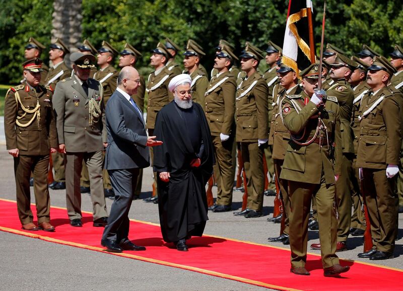 Iraq's President Barham Salih walks with Iranian President Hassan Rouhani during a welcome ceremony at Salam Palace in Baghdad, Iraq. REUTERS
