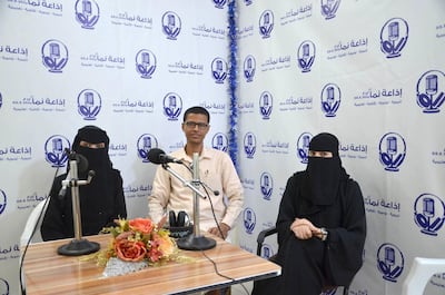 Majedi Bazyad, centre, the manager of Nama radio station, with two of his journalists. He says community radios in Al Mukallah have played a critical role in spreading important information about diseases.  Saeed Al Batati for The National