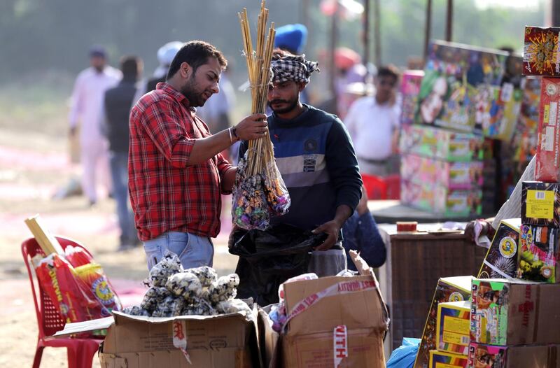 Indian people shop for firecrackers at a shop on the eve of Diwali in Amritsar, India.  EPA