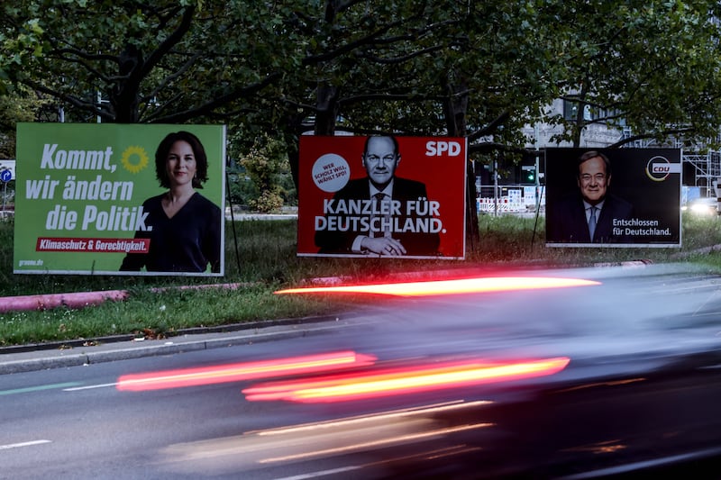 Election campaign posters on a roadside in Berlin show the top candidates Annalena Baerbock, Mr Scholz and Armin Laschet. EPA