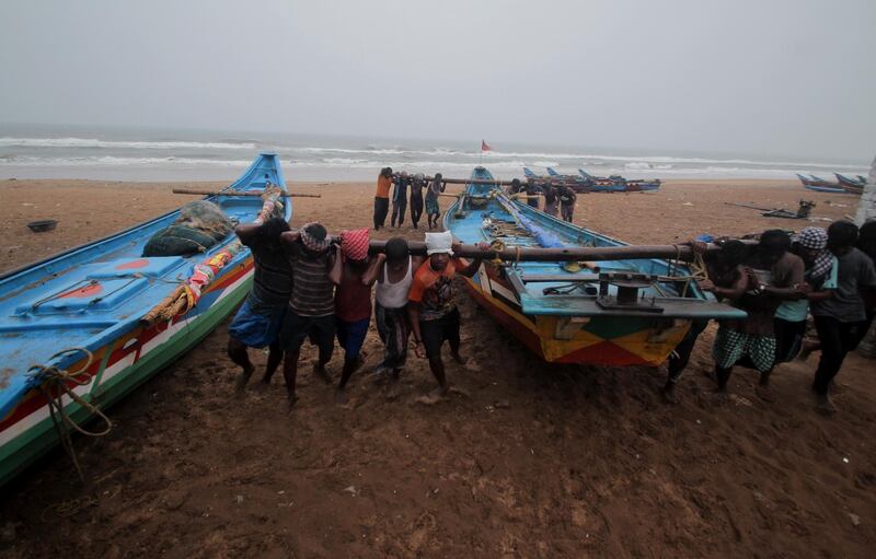 Fishermen move their boats to safer ground as a precaution against Cyclone Yaas, along the Bay of Bengal coast, in Odisha, India. AP