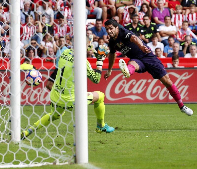 Barcelona forward Luis Suarez scores the opening goal. Jose Luis Cereijido / EPA