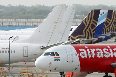 Aircraft operated by AirAsia Bhd, Vistara, a joint venture between Singapore Airlines and Tata Group, and IndiGo, a unit of InterGlobe Aviation Ltd., stand at Terminal 3 of Indira Gandhi International Airport in New Delhi, India, on Sunday, June 28, 2020. India, which allowed airlines to resume domestic flights from May 25, has put restrictions on fares and capacity deployed making their viability more difficult at a time when the industry’s recovery is seen to be long and slow. Photographer: T. Narayan/Bloomberg