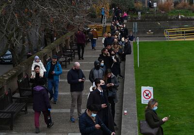 People queue outside a vaccination centre at the St Thomas’ Hospital in London for Covid-19 booster shots. EPA