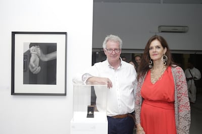 Artists Christopher Osbourne and Lia Staehlin pose next to their works. Staehlin designed 'Coco Ring', which she wears in the photo taken by Osbourne hanging on the left. Courtesy Tashkeel
