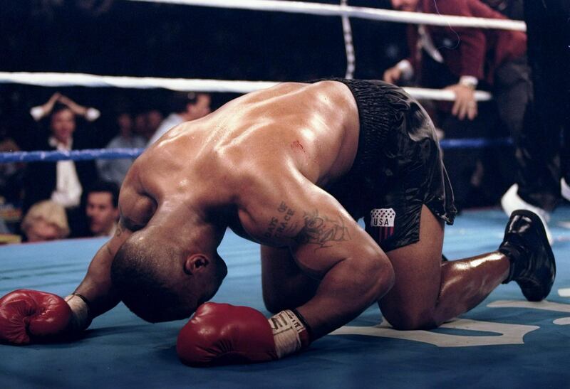 16 Mar 1996: Mike Tyson falls to his knees in celebration after knocking out Frank Bruno of Great Britain in the third round of the WBC Heavyweight Championship bout at the MGM Grand Garden in Las Vegas, Nevada. Mandatory Credit: Al Bello  /Allsport / Getty Images