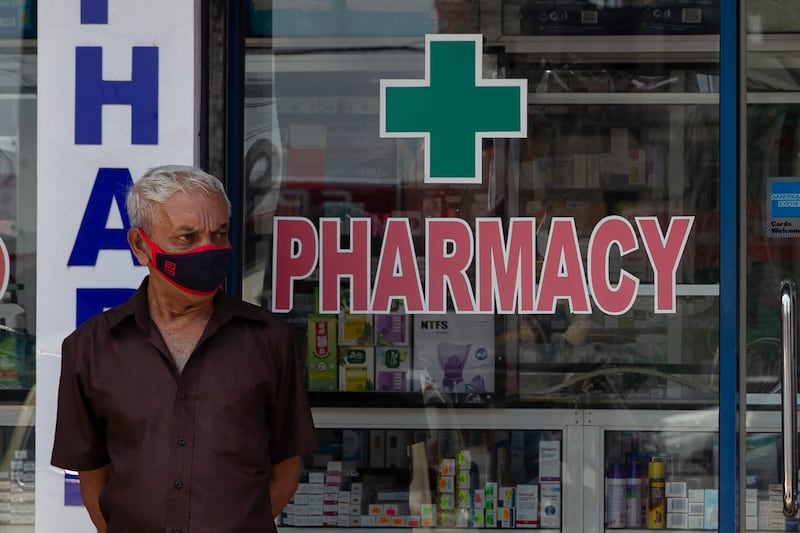 A man stands outside a pharmacy in Colombo. Getty Images