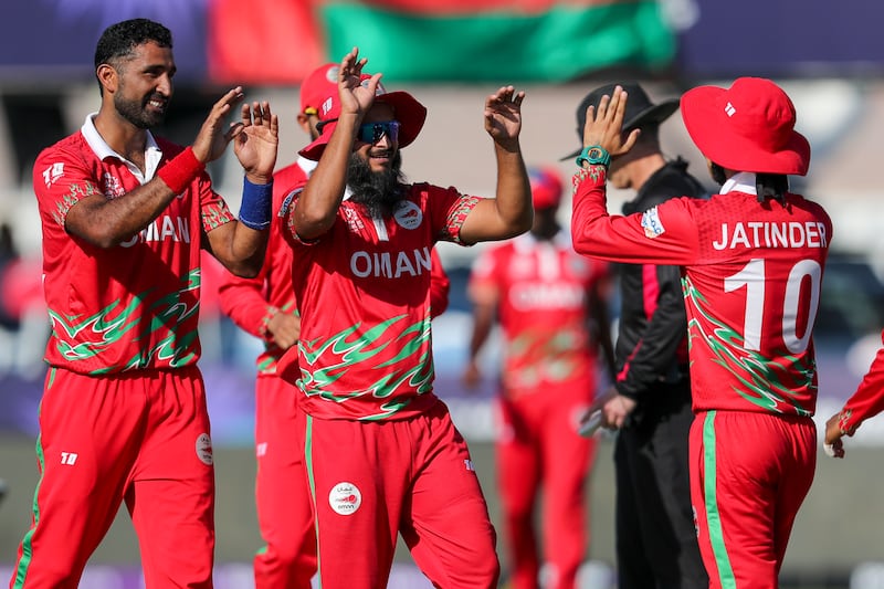 Oman's Jatinder Singh, right, is congratulated by teammates after taking a catch against Papua New Guinea. AP