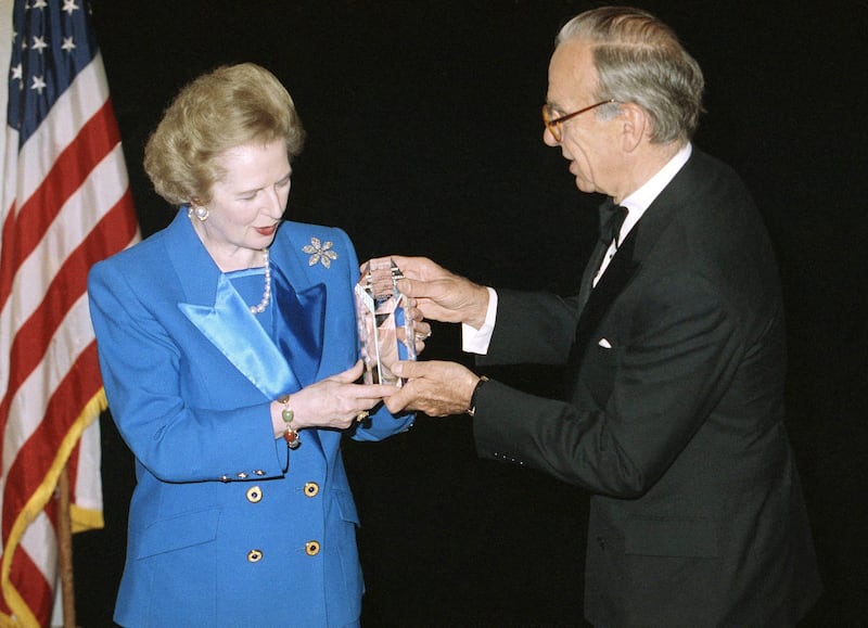 FILE - In this Nov. 14, 1991, file photo, Margaret Thatcher accepts the United Cerebral Palsy of New York's 37th Annual Humanitarian Award in New York from Rupert Murdoch. Murdoch is a political kingmaker in England and his native Australia. In the United States, he’s best known for promoting conservative opinion through media properties like the Fox News Channel. Murdoch is not as personally connected to political leadership in the U.S., where he is a naturalized citizen. Murdoch began building his power in Britain in the 1980s, when former Prime Minister Margaret Thatcher, the Conservative Party leader, allowed Murdoch to add The Times and The Sunday Times to his stable of media properties including The Sun and News of the World, the tabloid been primarily connected to the hacking scandal. (AP Photo/Mike Albans, File) *** Local Caption ***  Murdoch Politics.JPEG-0aac6.jpg