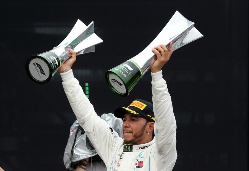 FILE PHOTO: Formula One F1 - Brazilian Grand Prix - Autodromo Jose Carlos Pace, Interlagos, Sao Paulo, Brazil - November 11, 2018  Mercedes' Lewis Hamilton celebrates after winning the race with the constructors championship trophy and the race trophy  REUTERS/Paulo Whitaker/File Photo