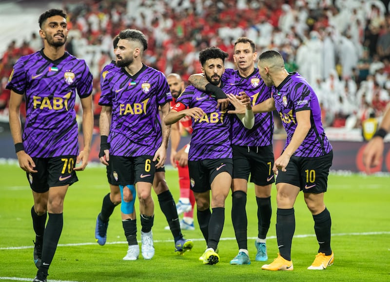 Al Ain players celebrate their first goal. 