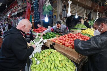 People shop at a public fresh produce market in Jordan's capital Amman, on April 5, 2021, after a rare security operation took place in the country. - Jordan's Prince Hamzah, accused by the government of a "wicked" plot against his elder half-brother King Abdullah II, insisted he will not obey orders restricting his movement. The government has accused him of involvement in a seditious conspiracy to "destabilise the kingdom's security", placed him under house arrest and detained at least 16 more people. (Photo by Khalil MAZRAAWI / AFP)