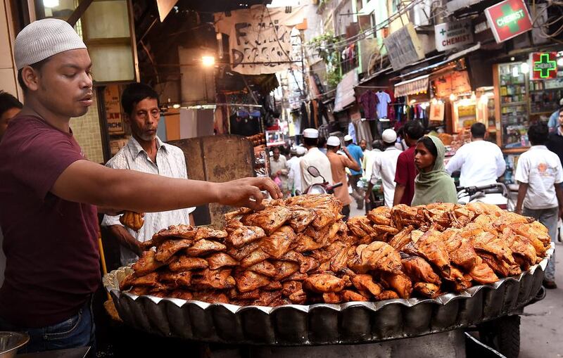 Dozens of temporary food vendors set up shop along the length of the alley during Ramadan. Harish Tyagi/EPA