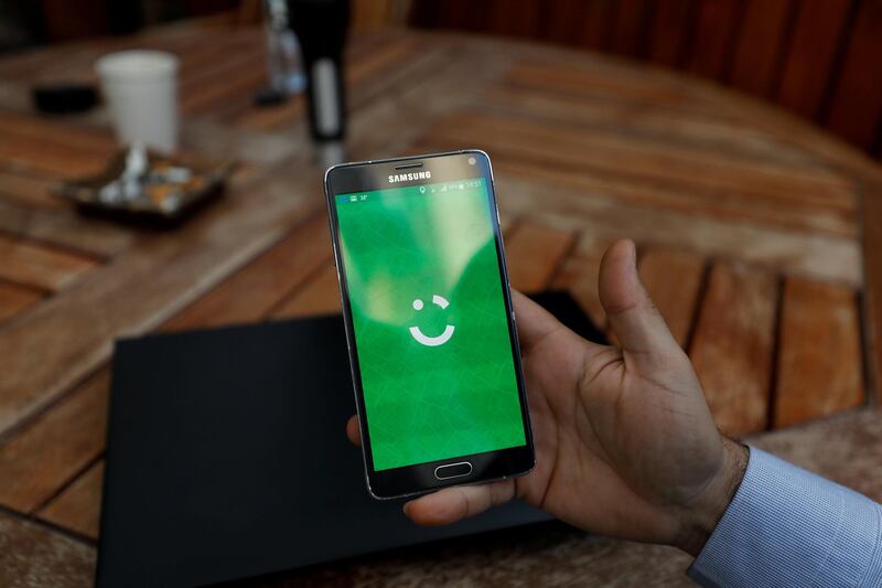 FILE PHOTO: An employee shows the logo of ride-hailing company Careem on his mobile in his office in the West Bank city of Ramallah July 17, 2017. REUTERS/Mohamad Torokman/File Photo