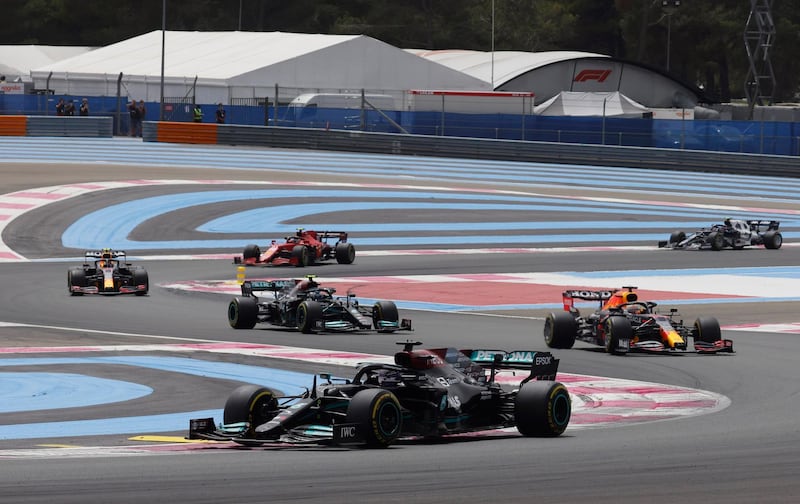Lewis Hamilton ahead of Max Verstappen's Red Bull and his Mercedes teammate Valtteri Bottas. Reuters
