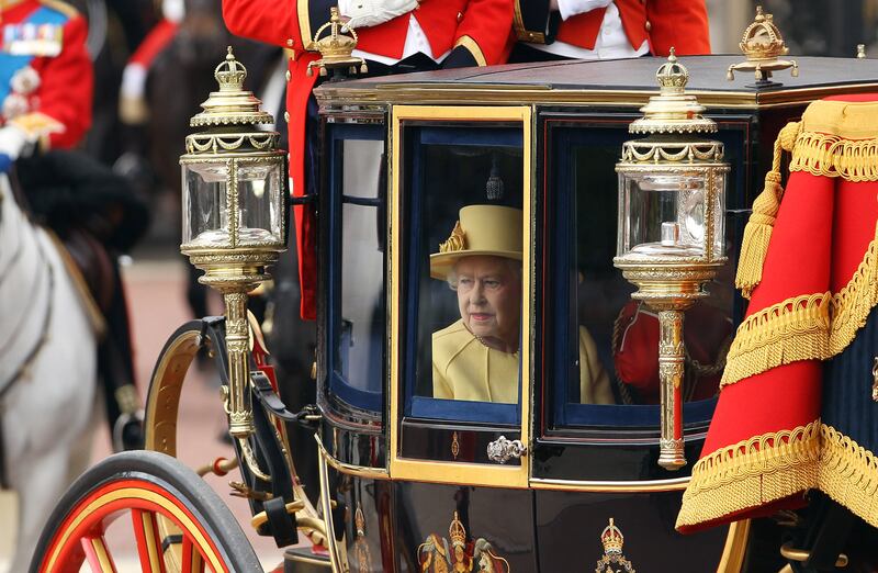 Queen Elizabeth, accompanied by Prince Philip, leaves Buckingham Palace for the Trooping the Colour ceremony in 2012