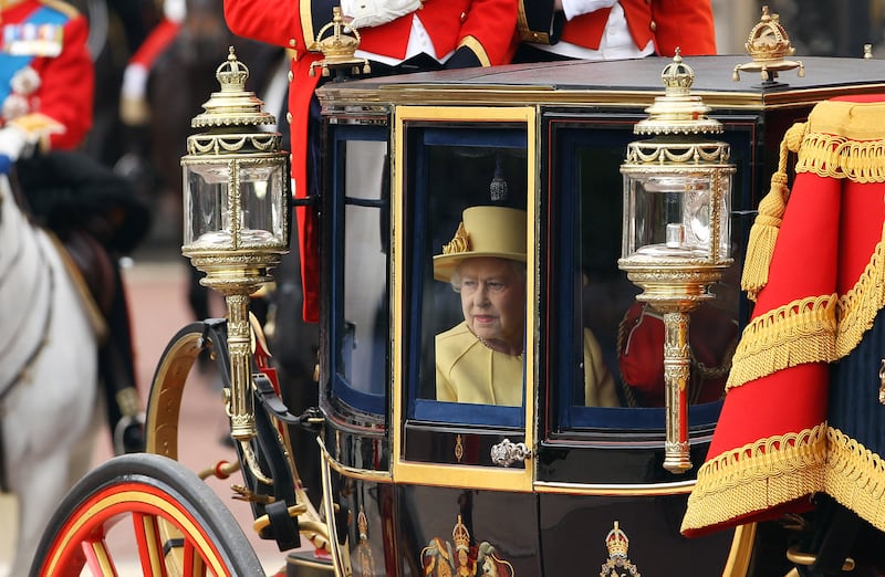 Queen Elizabeth, accompanied by Prince Philip, leaves Buckingham Palace for the Trooping the Colour ceremony in 2012