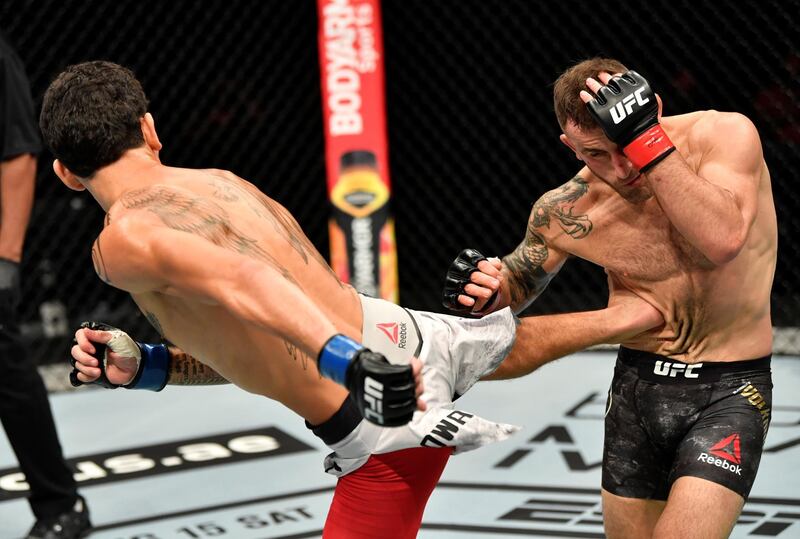 ABU DHABI, UNITED ARAB EMIRATES - JULY 12: (L-R) Max Holloway kicks Alexander Volkanovski of Australia in their UFC featherweight championship fight during the UFC 251 event at Flash Forum on UFC Fight Island on July 12, 2020 on Yas Island, Abu Dhabi, United Arab Emirates. (Photo by Jeff Bottari/Zuffa LLC)