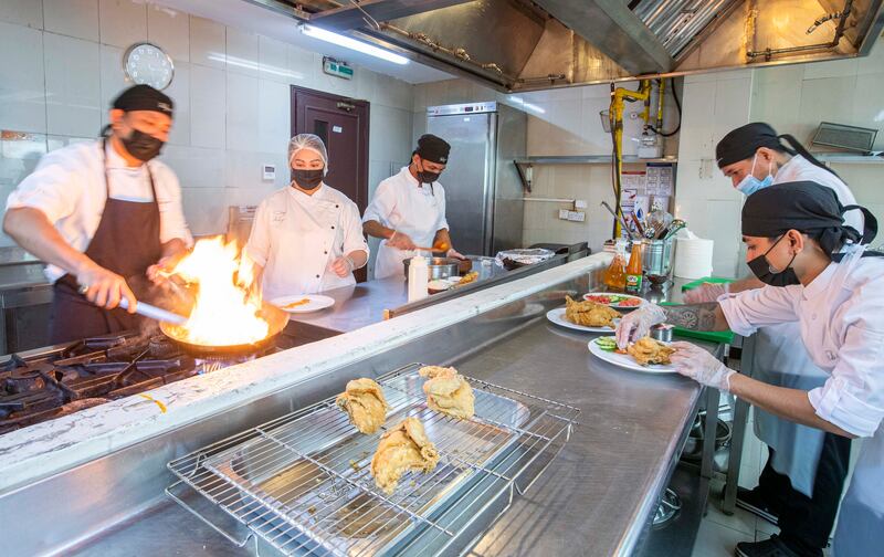 Feby Baguisa at work in the kitchen along with her staff. 