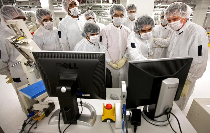 Dresden, Germany - July 20, 2010 - Jens Kober (R) manager of Test Engineering shows students from the UAE how silicon wafers are tested after the production process in Test Floor at GLOBALFOUNDRIES Fab 1 in Dresden, Germany, July 20, 2010. (Photo by Jeff Topping/The National) 
