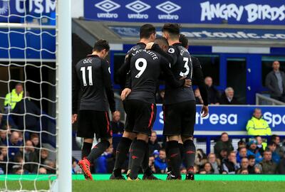 Arsenal's Alexandre Lacazette, center, celebrates scoring his side's third goal against Everton during the English Premier League soccer match at the Goodison Park, Liverpool, England, Sunday Oct. 22, 2017. (Peter Byrne/PA via AP)