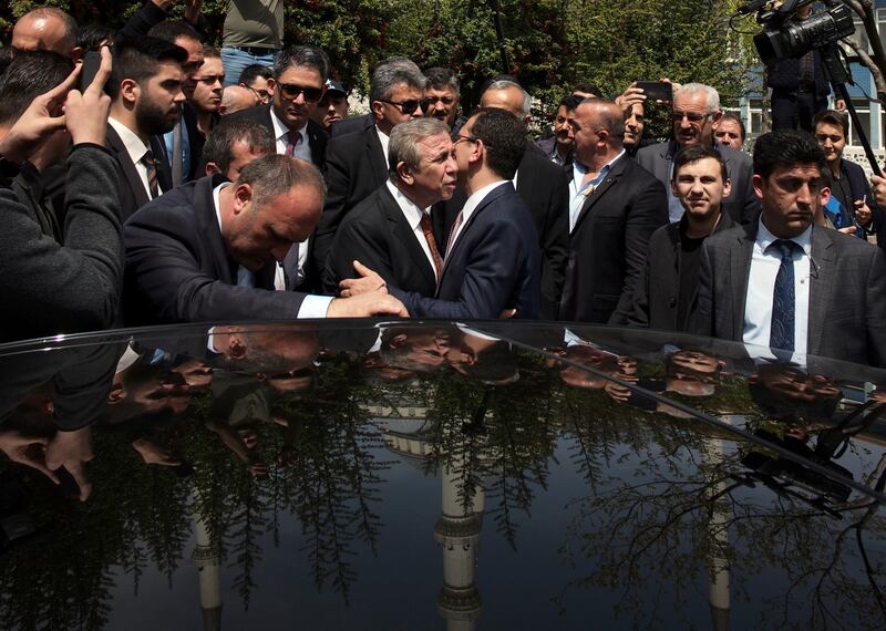 Ekrem Imamoglu, the new mayor of Turkey's biggest city, Istanbul, centre right, and Mansur Yavas, the new mayor of Turkish capital, Ankara, both from the main opposition Republican People's Party, embrace as they leave Kocatepe Mosque after Friday prayers, in Ankara, Turkey, Friday, April 26, 2019. Turkish authorities confirmed last week Imamoglu as the mayor of Istanbul, ending more than two weeks of recounts of the March 31 vote demanded by President Recep Tayyip Erdogan's ruling party.(AP Photo/Burhan Ozbilici)