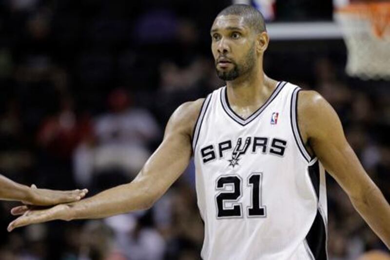 San Antonio Spurs' Tim Duncan is congratulated as he walks off the court during the third quarter of an NBA basketball game against the Portland Trail Blazers, Monday, April 23, 2012, in San Antonio. San Antonio won 124-89, clinching the top seed in the Western Conference.  (AP Photo/Eric Gay)