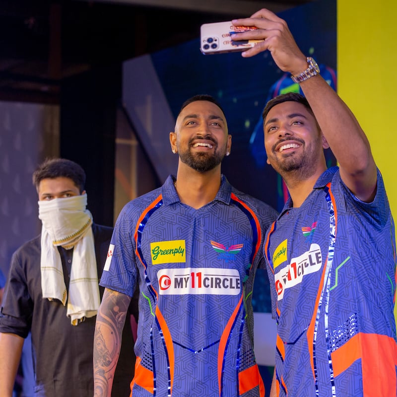 Lucknow Super Giants players Krunal Pandya, left, and Avesh Khan with their IPL 2023 jersey. @LucknowIPL / Twitter