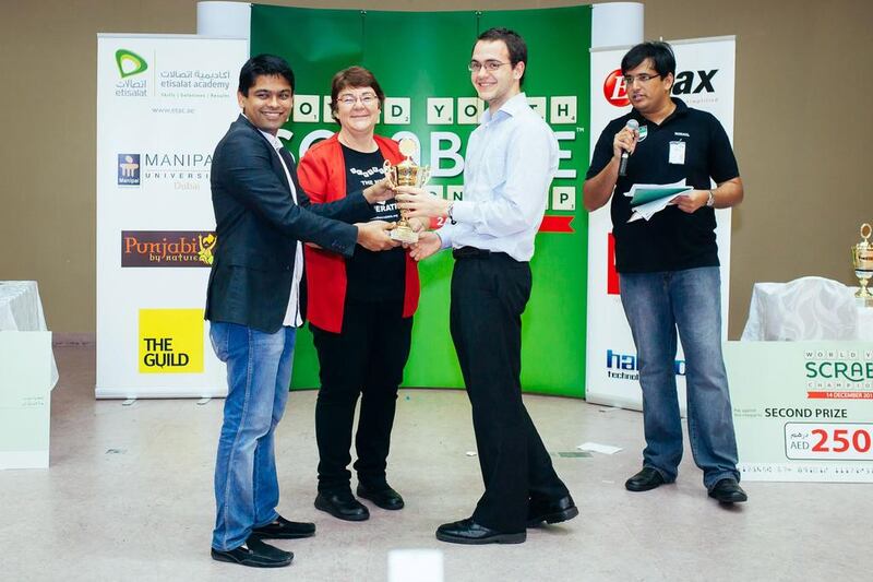 Karen Richards, second from left, presenting Alistair Richards, second from right, an award for winning the adult side tournament at the 2013 World Youth Scrabble Championship (WYSC) in Dubai. They will conduct a scrabble workshop. Courtesy of Faisal Khatib