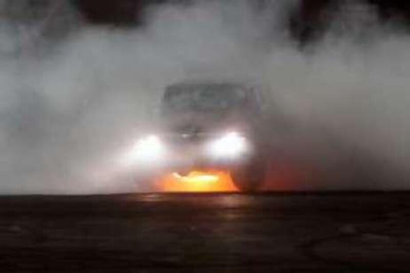United Arab Emirates - Al Ain - May 2 - 2008 : A driver perform vehicular stunts, burning tires and making plumes of smoke, during the Gulf Car Performance Championship in Al Ain Sportplex. ( Jaime Puebla - The National ) *** Local Caption *** JP116 - GULF CAR PERFORMANCE CHAMPIONSHIP.jpg