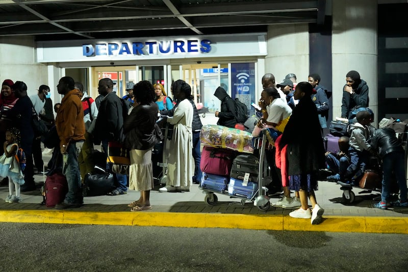 Zimbabwean evacuees from Sudan are seen upon arrival at Robert Mugabe International airport in Harare, Zimbabwe.  AP Photo 