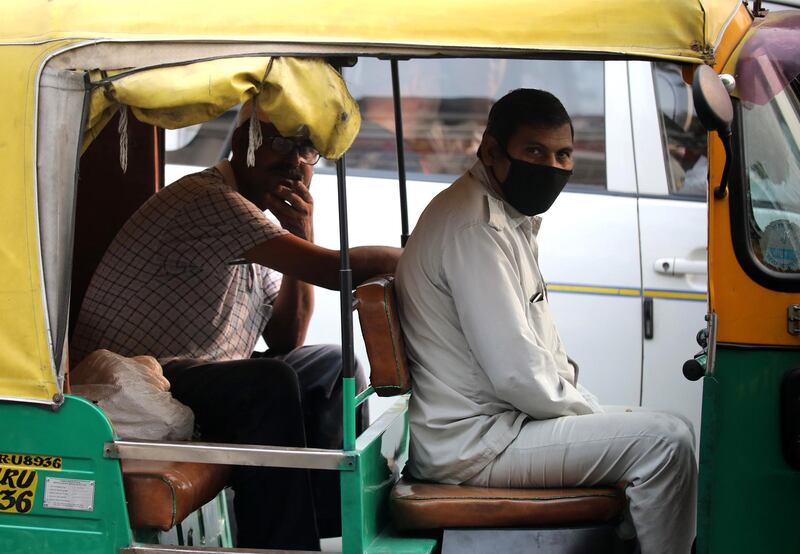An Indian auto rickshaw driver wears a mask during heavy smog in New Delhi, India.  EPA