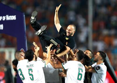 Algeria's players throw their head coach Djamel Belmadi in the air after the African Cup of Nations final soccer match between Algeria and Senegal in Cairo International stadium in Cairo, Egypt, Friday, July 19, 2019. Algeria won 1-0. (AP Photo/Ariel Schalit)