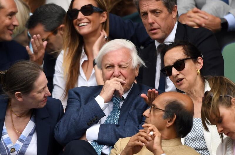 Sir David Attenborough, centre, sits in the Royal Box on Centre Court. Wimbledon always attracts a host of celebrities, but they are set to miss out this year.  AP