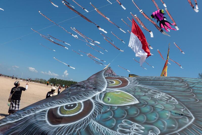 Balinese people fly kites during a kite festival held to celebrate Indonesian Independence Day in Bali, Indonesia.  EPA