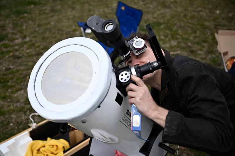 A man sets up his telescope ahead of the eclipse in Kingston, Ontario, Canada. The Canadian Press / AP